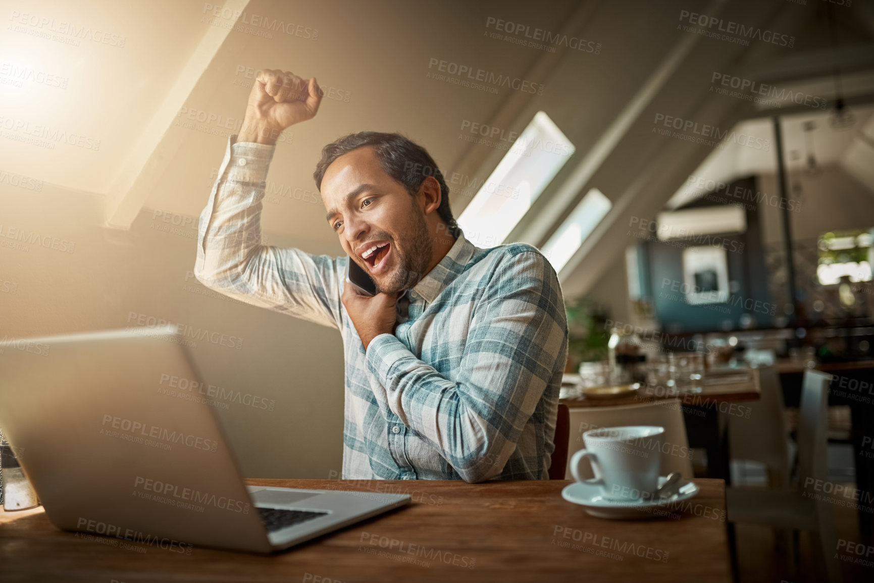 Buy stock photo Man, laptop and excited with fist pump in phone call in restaurant with good news or achievement as freelancer. Male person, remote work and happy as journalist for communication and networking