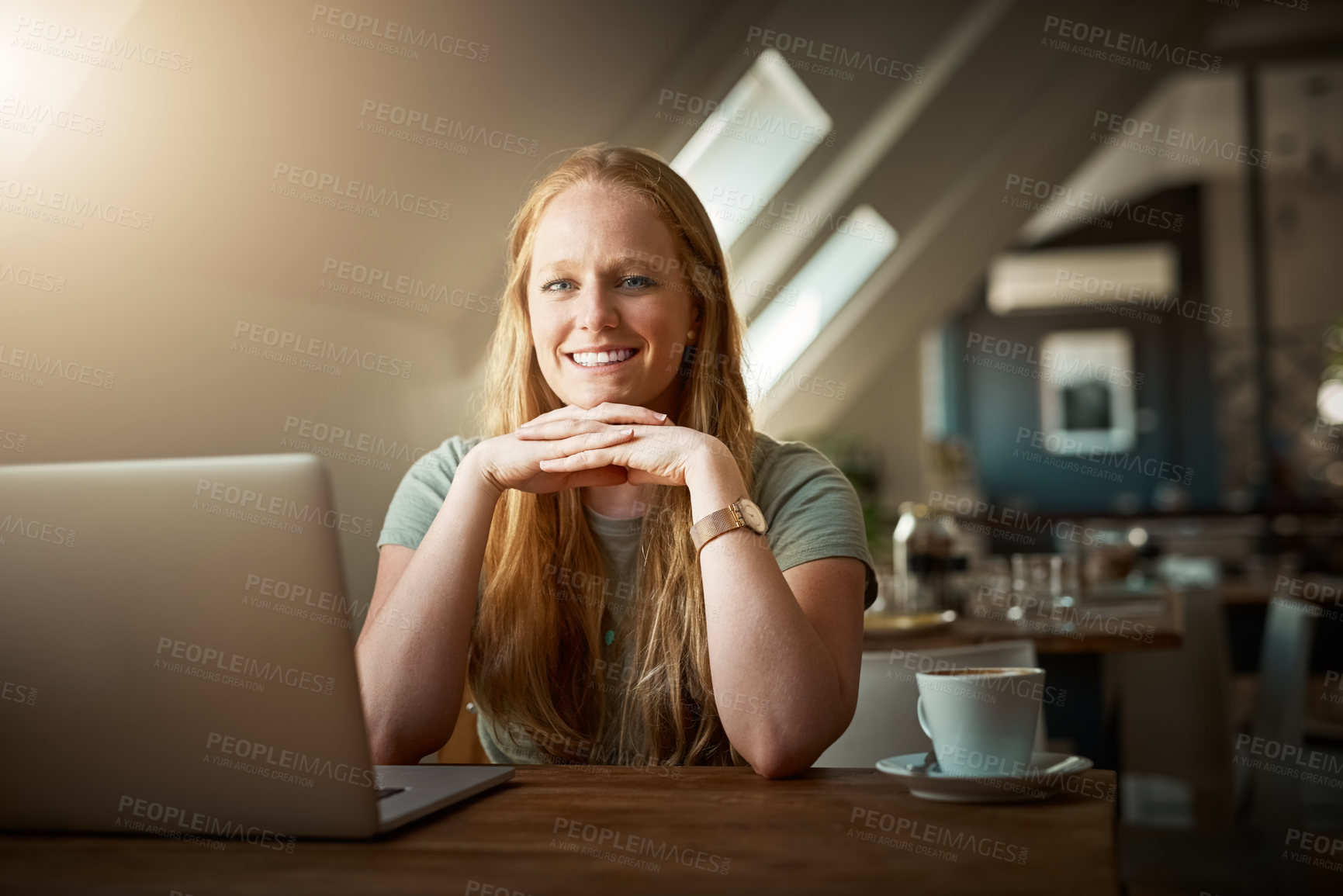 Buy stock photo Shot of a young woman using her laptop in a coffee shop