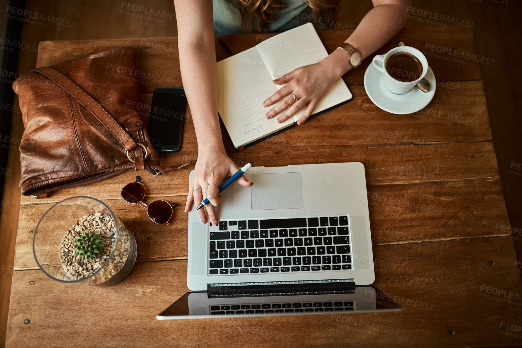 Buy stock photo Above, hands and notebook with laptop at coffee shop as journalist for headline story or article. Person, restaurant and remote work as blogger or freelancer for creativity and research for trends