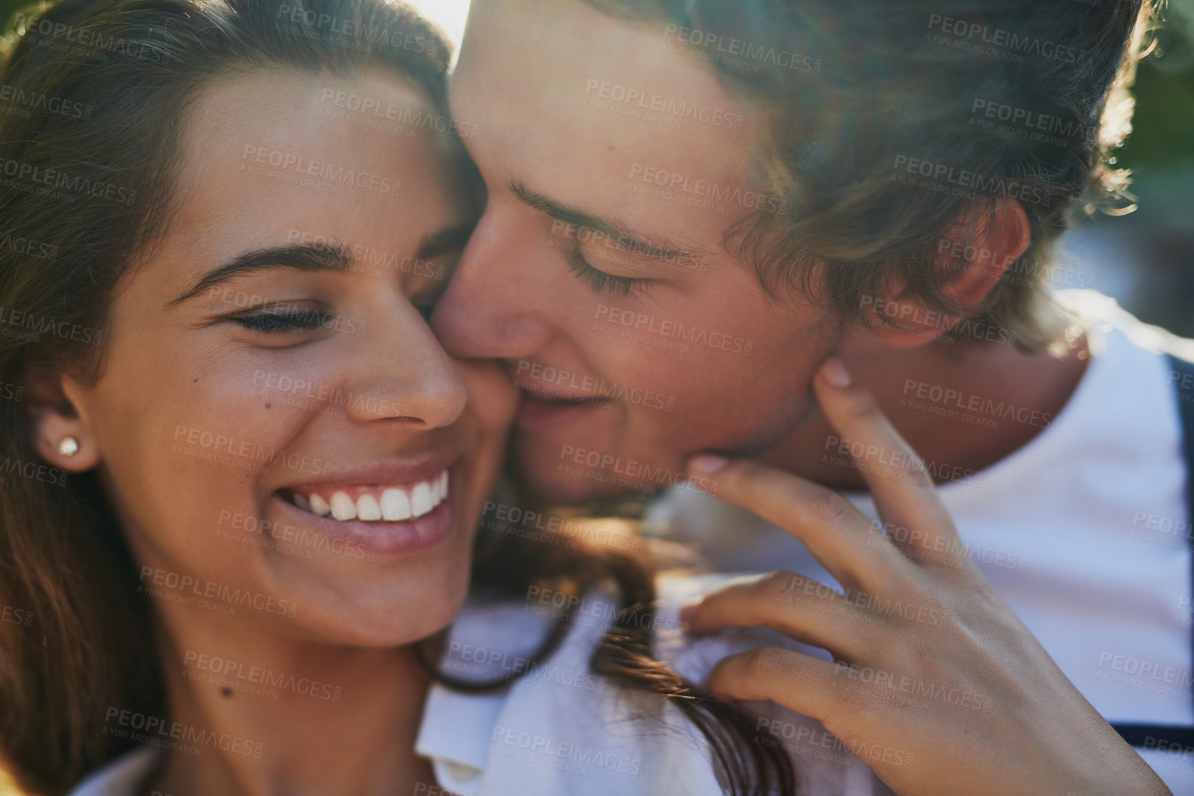 Buy stock photo Shot of an affectionate young couple bonding outdoors