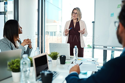 Buy stock photo Shot of a businesswoman giving a presentation to her colleagues in an office