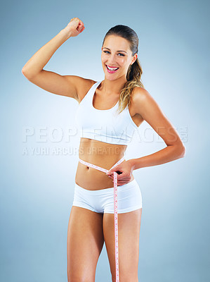 Buy stock photo Happy woman, portrait and flex with measuring tape for lose weight, diet or strength in studio on a blue background. Young female person or model with smile for slim body, gym goals or achievement