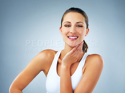 Buy stock photo Studio shot of a beautiful and healthy young woman against a blue background