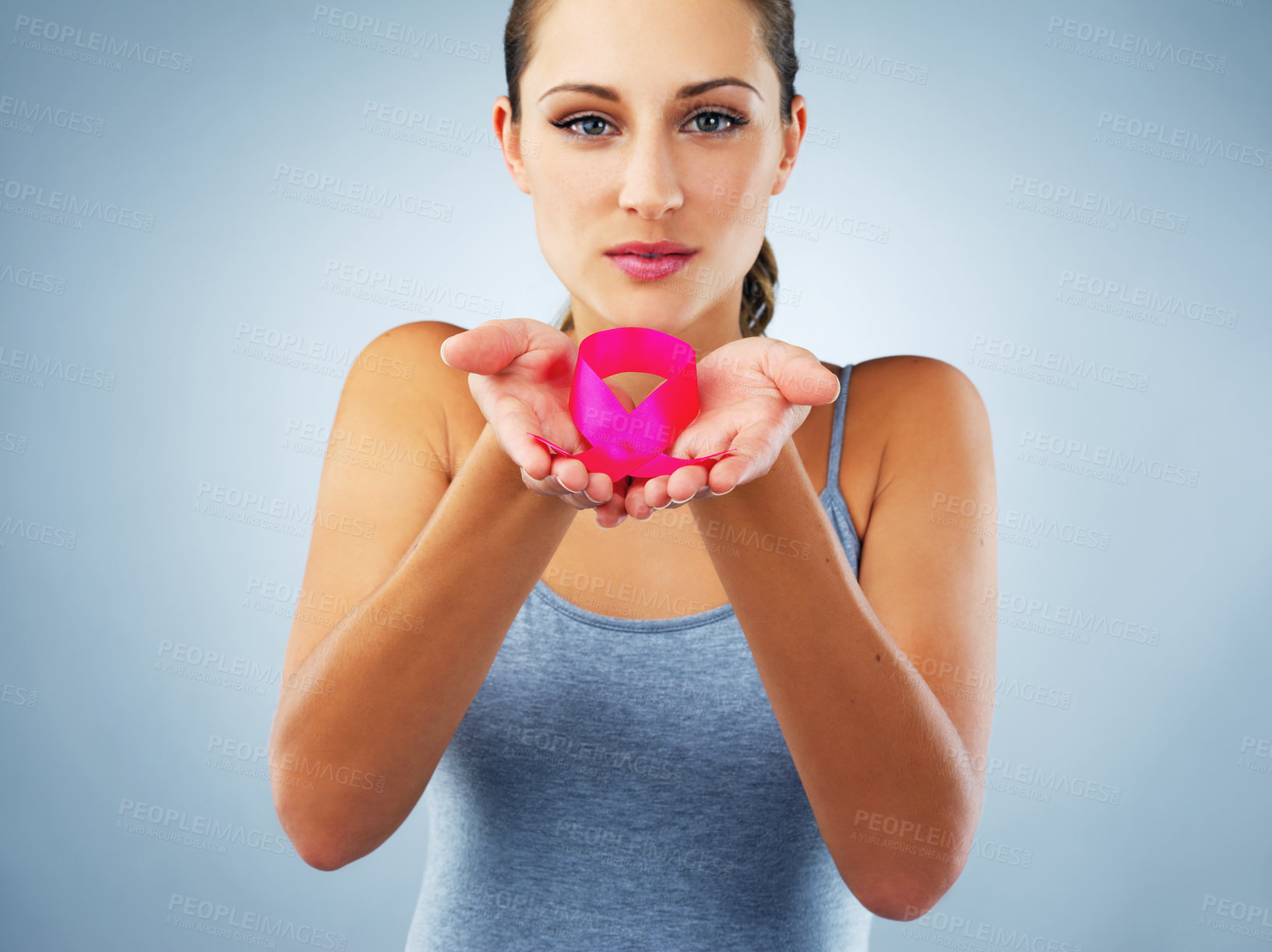 Buy stock photo Woman, portrait and ribbon in studio for breast cancer with awareness, support and care by blue background. Person, pink fabric and sign for call to action, test or check for wellness with empathy