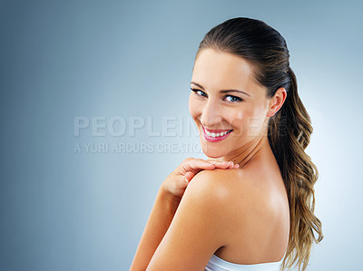 Buy stock photo Studio shot of a beautiful and healthy young woman against a blue background