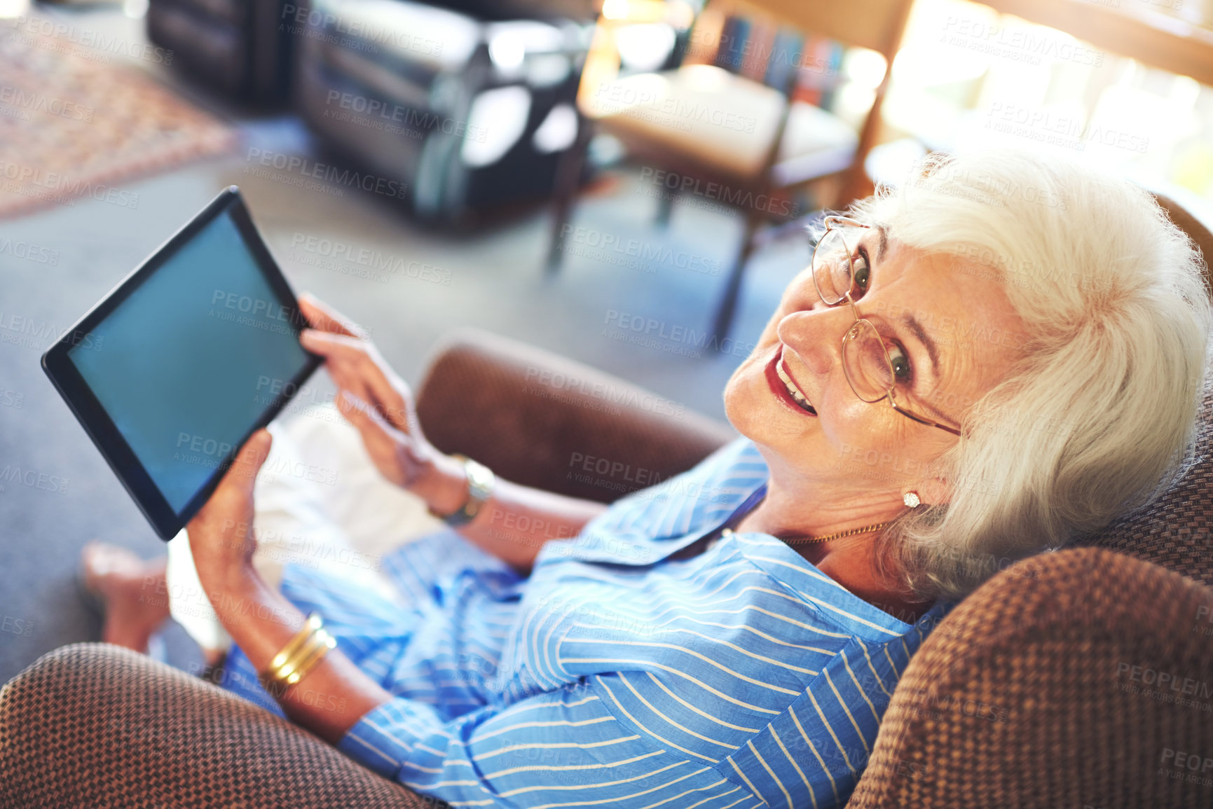 Buy stock photo Senior woman, portrait and tablet on sofa for streaming, internet and video call in home living room. Elderly person, smile and tech on couch with helping hand for social media, app or communication