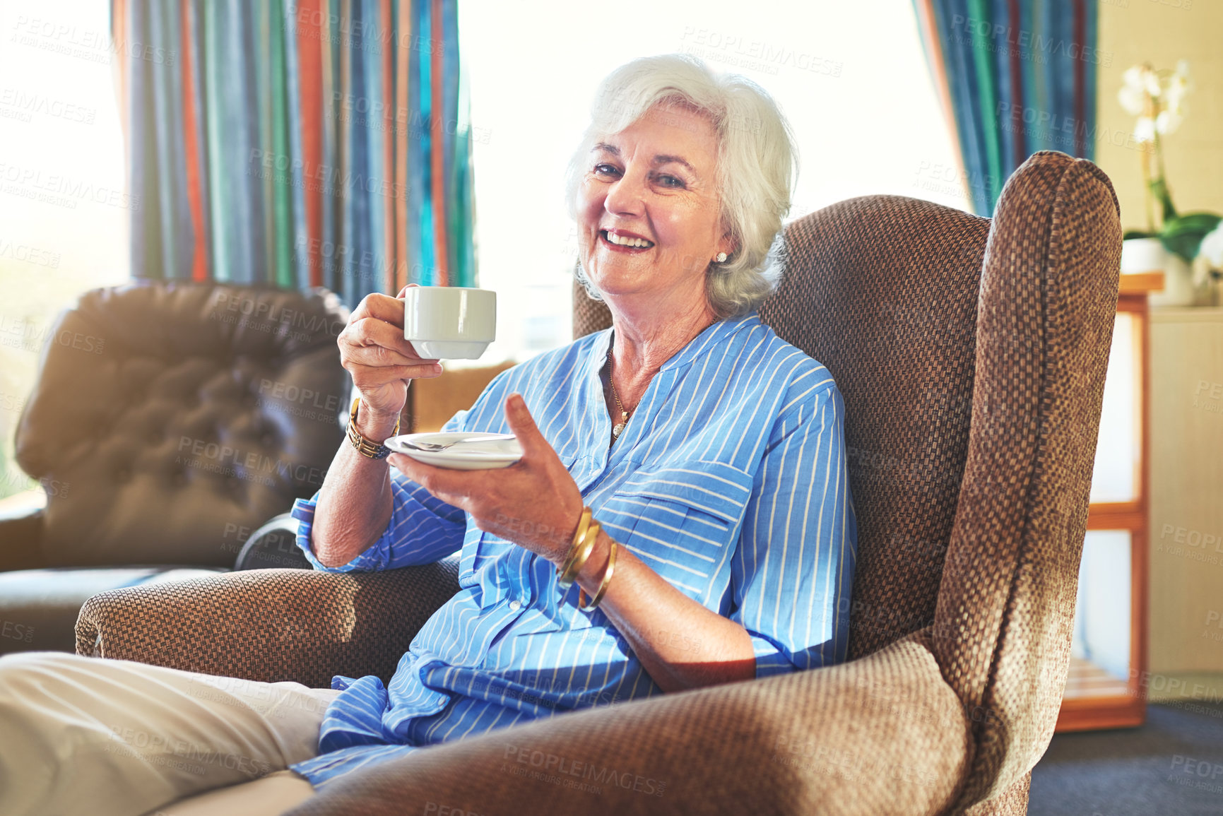 Buy stock photo Cropped shot of a senior woman drinking a cup of tea at home