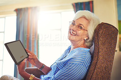 Buy stock photo Cropped shot of a senior woman using a tablet at home