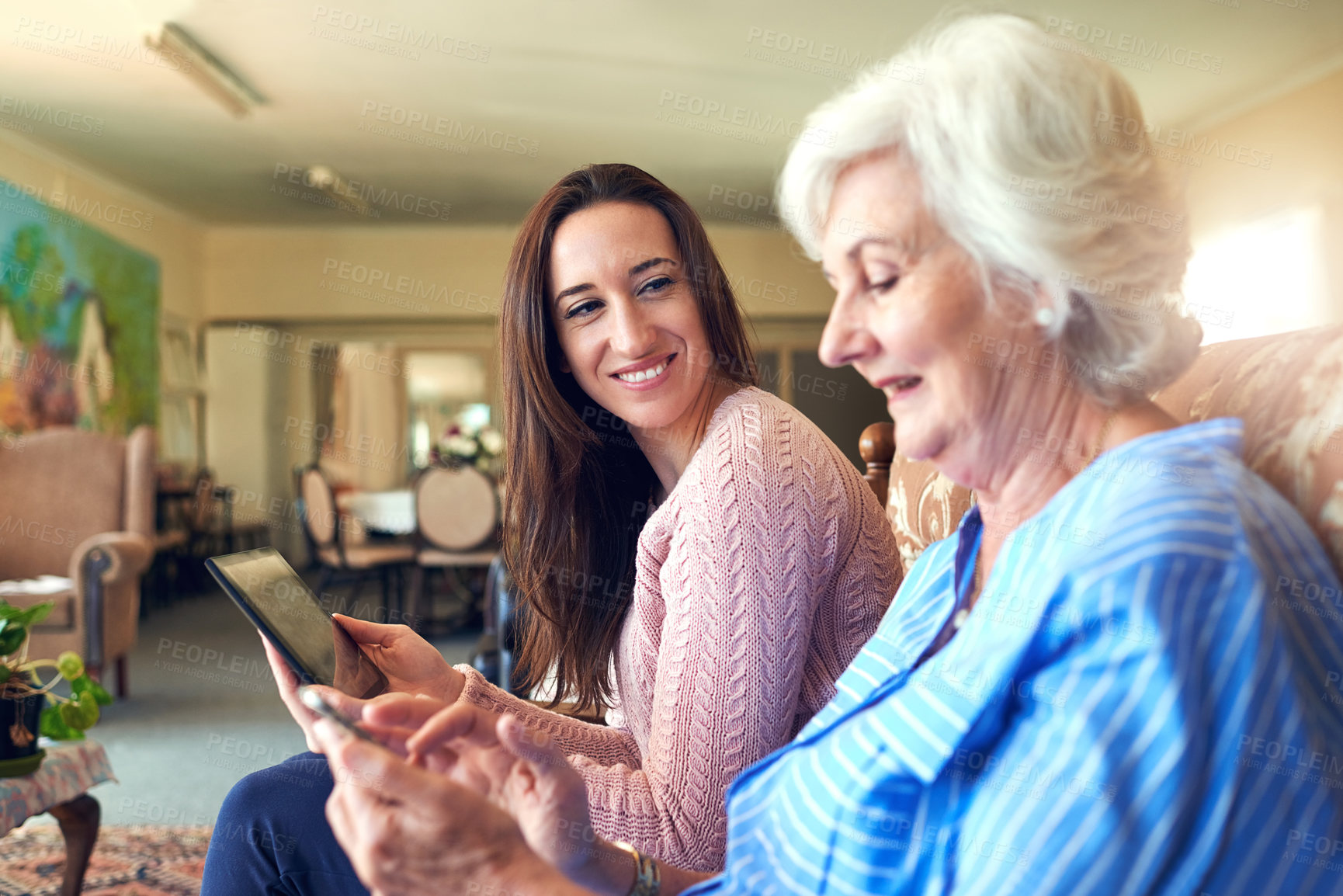 Buy stock photo Senior woman, grandchild and technology in living room for visit, help or elderly care as family. Female people, communication and love in retirement home for weekend on couch together with bonding