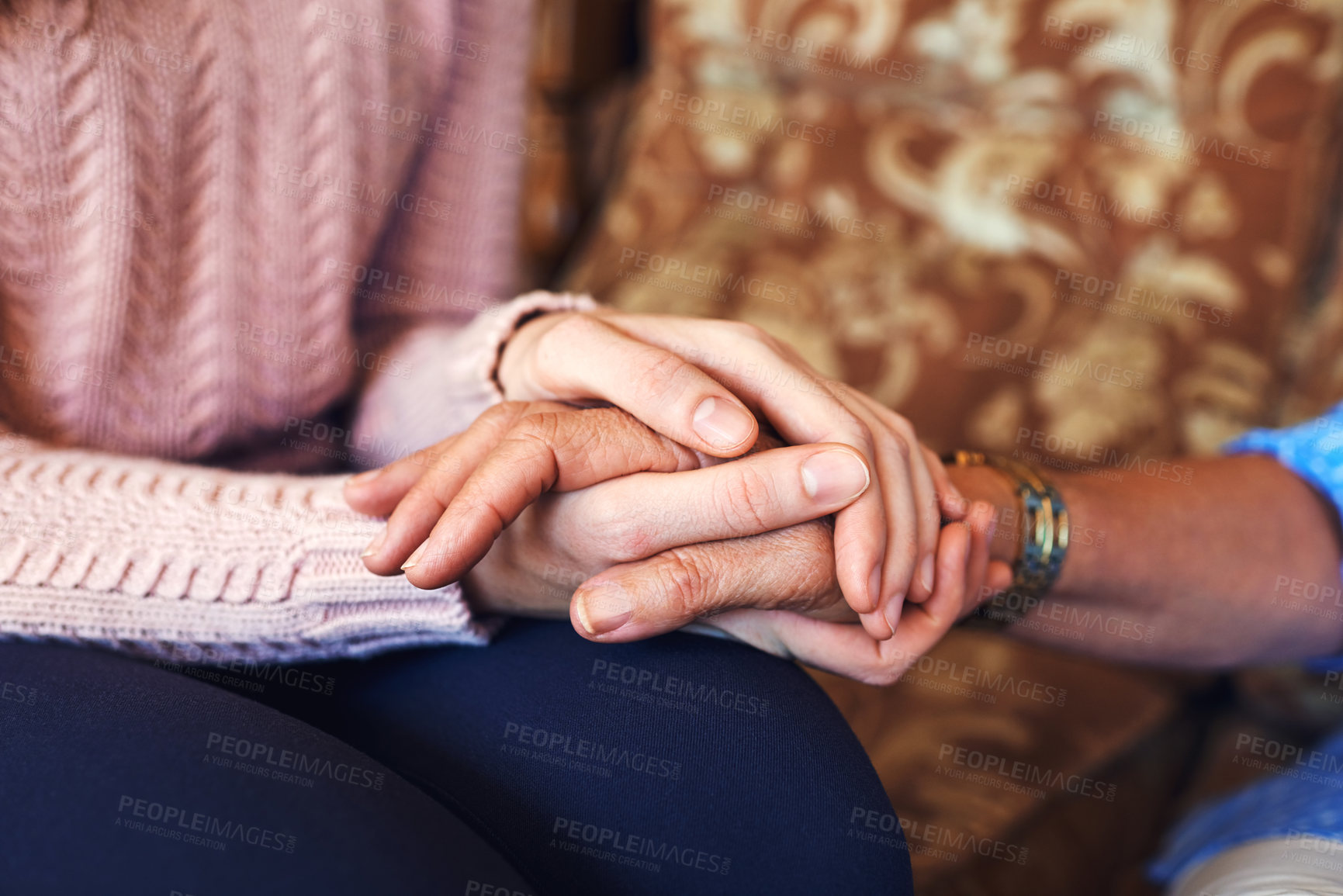 Buy stock photo Cropped shot of unrecognizable women holding hands at home