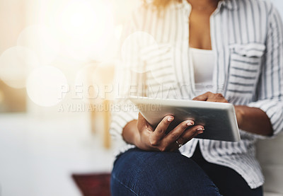 Buy stock photo Tablet technology in the hands of a woman browsing social media, surfing the internet or chatting online with flare and copyspace. Closeup of a female sending an email message or reading news
