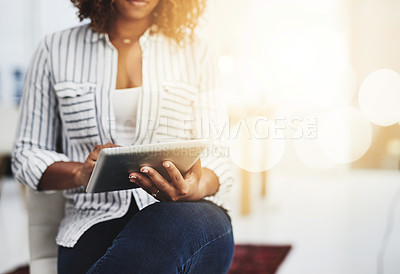 Buy stock photo Business woman typing on a tablet, replying to emails and checking notifications while sitting in office at work. Manager, professional worker and creative designer searching the internet for ideas 