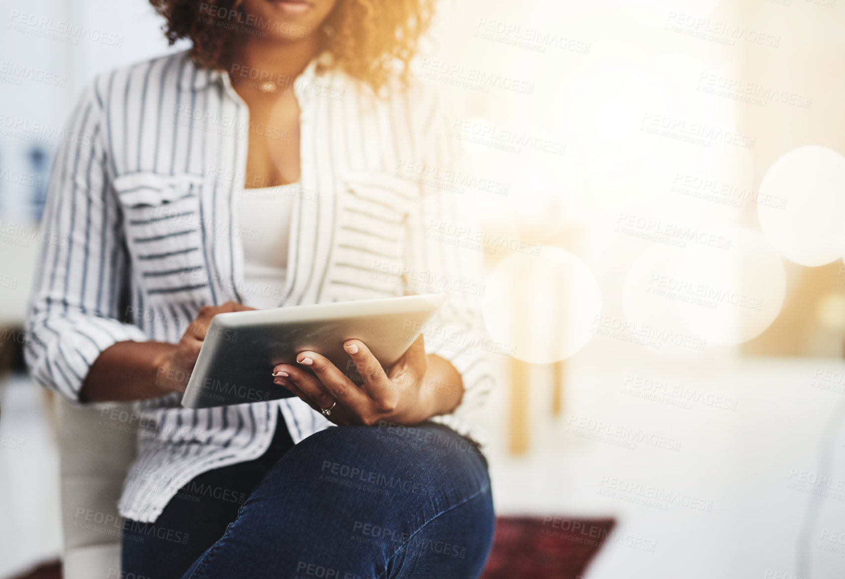 Buy stock photo Business woman typing on a tablet, replying to emails and checking notifications while sitting in office at work. Manager, professional worker and creative designer searching the internet for ideas 