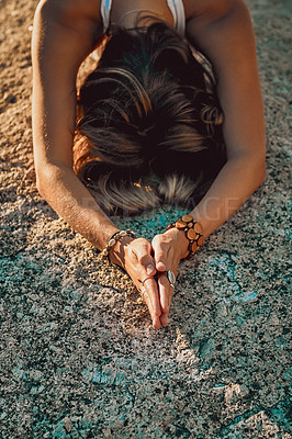 Buy stock photo Shot of a young woman practicing yoga on the beach