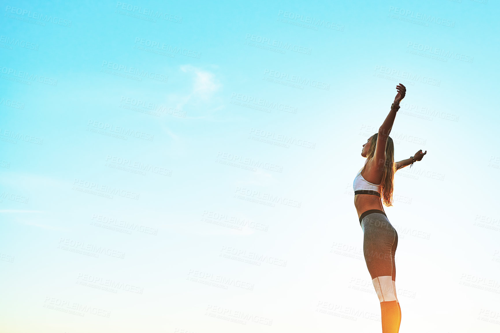 Buy stock photo Shot of an athletic young woman practicing yoga on the beach