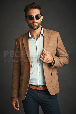 Buy stock photo Confident, man and fashion for portrait in studio with stylish, trendy and smart luxury clothes as Professor. Pride, male person and designer glasses, elegant and wealth suit on grey background
