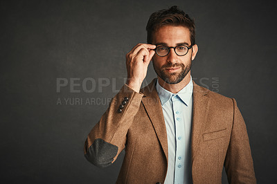 Buy stock photo Studio shot of a handsome young man posing against a gray background