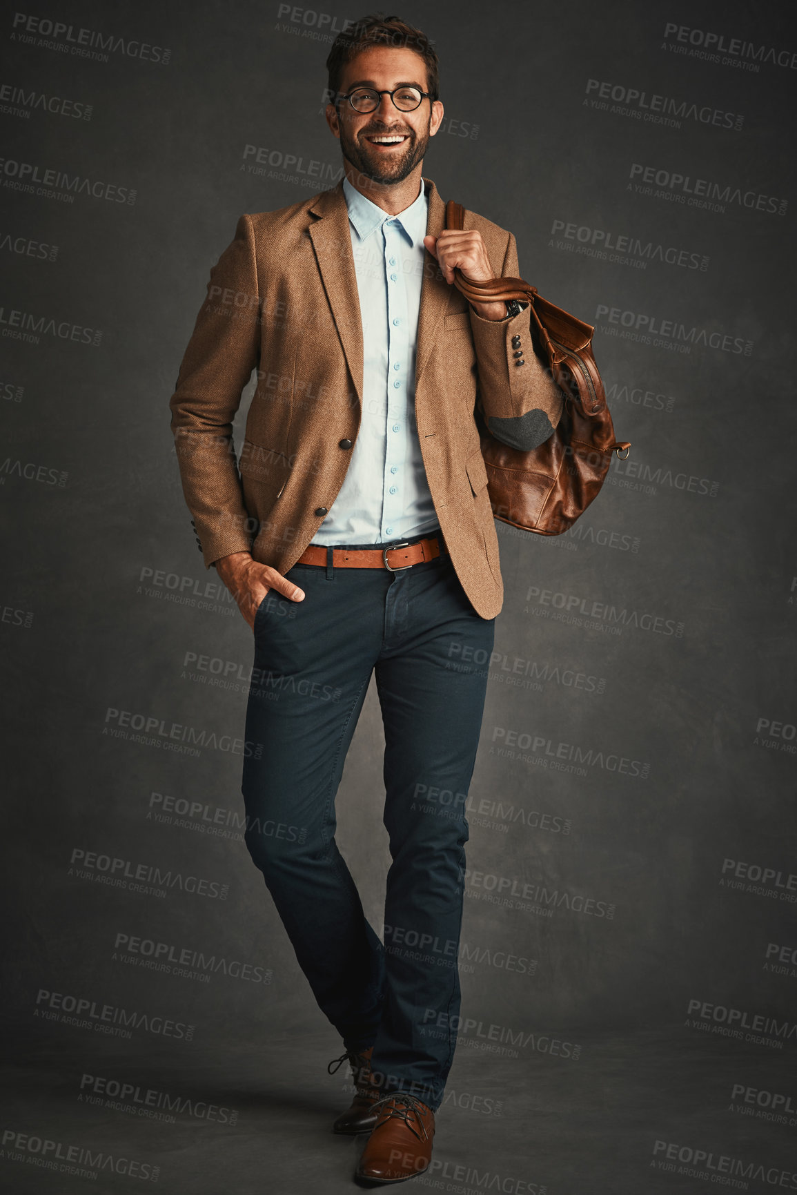 Buy stock photo Man, portrait and studio with bag for fashion, work gear and smart casual style for professional confidence. Male professor, gray background and glasses with jacket or cool, trendy blazer in Chicago