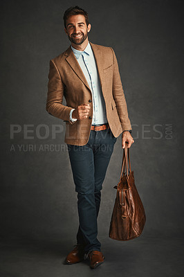 Buy stock photo Professor, portrait and studio with luggage for travel, work style or smart casual fashion for professional confidence. Man, gray background and bag with jacket or cool, trendy blazer in Chicago