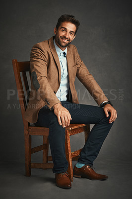 Buy stock photo Man, portrait and studio with chair for smile, work fashion or smart casual style for professional confidence. Male professor, gray background and pride with jacket or cool, trendy blazer in Chicago