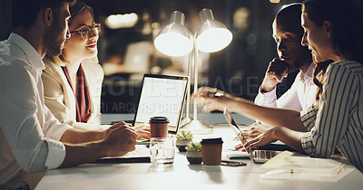 Buy stock photo Cropped shot of a group of businesspeople working around a table in the office