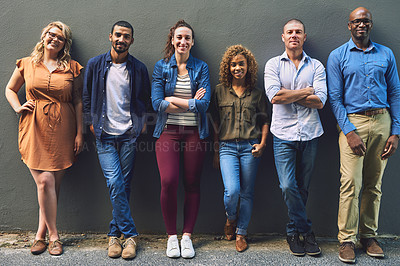Buy stock photo Shot of a group cheerful friends standing together for a portrait while looking at the camera