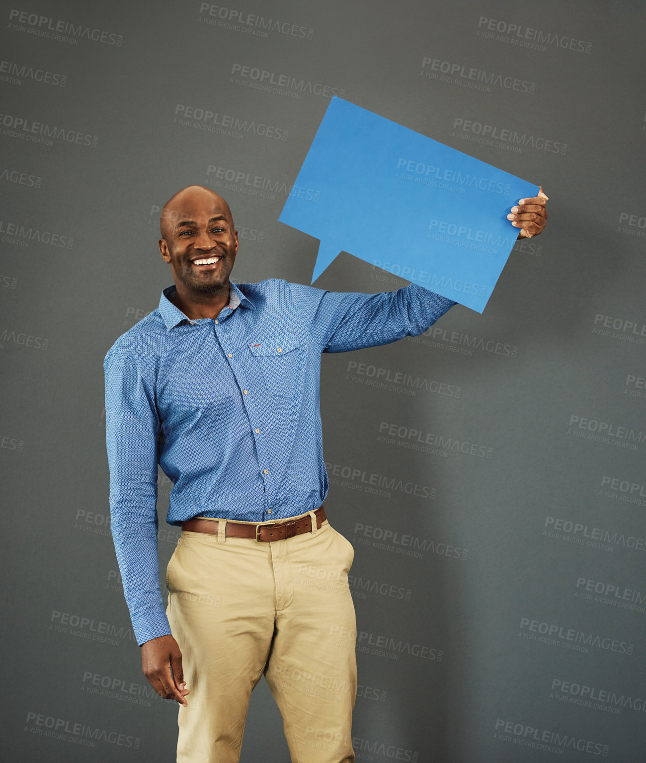 Buy stock photo Smiling, african american male voter holding a copyspace board sign on public opinion message. Casual and positive man holding a social media speech bubble or communication icon for news poll idea