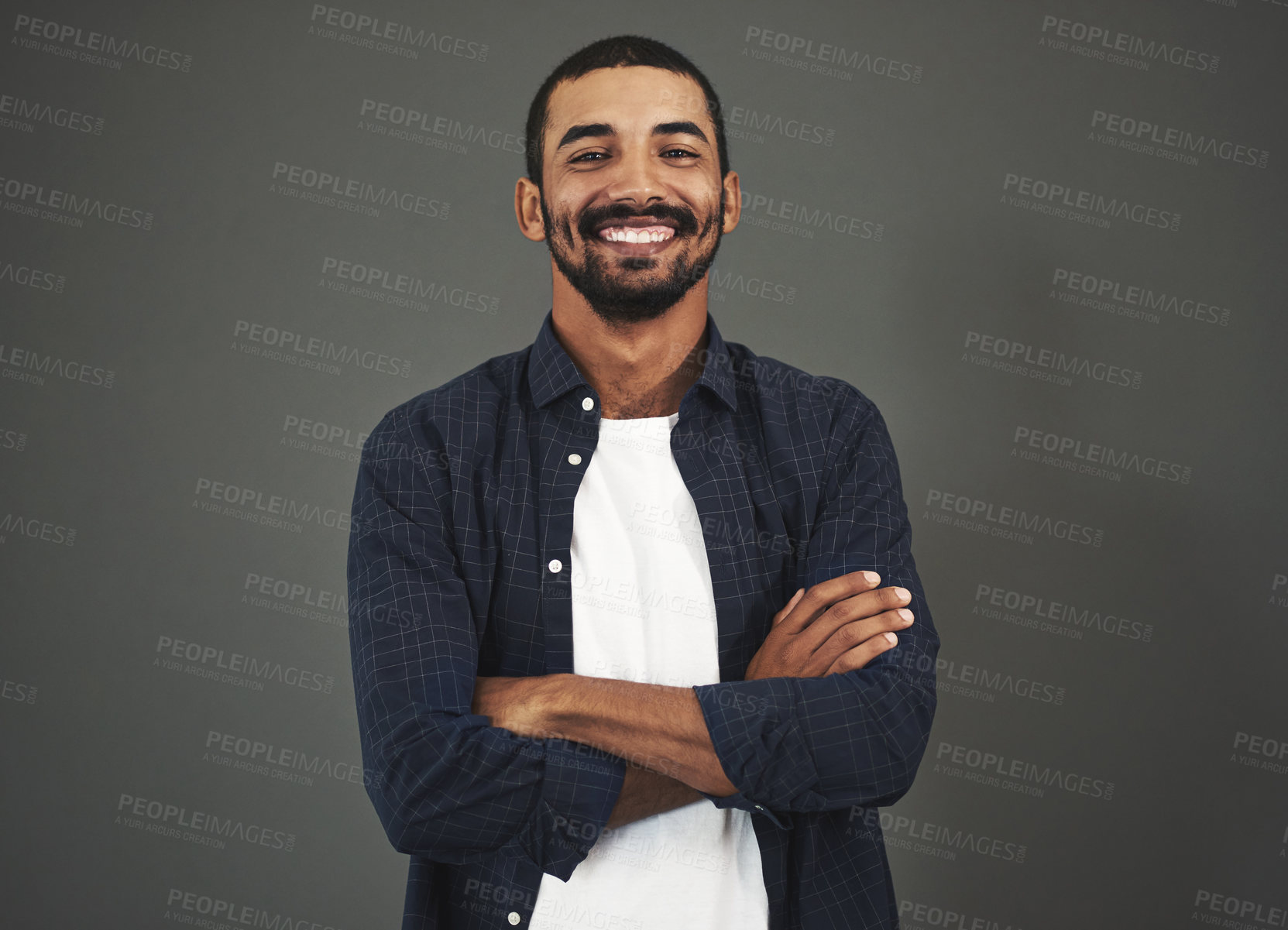 Buy stock photo Studio portrait of a confident man posing against a gray background