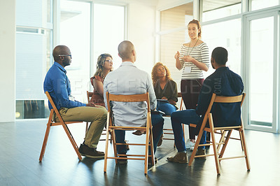Buy stock photo Female manager or CEO talking in a teamwork meeting about team development and success. Group of marketing team talking about a work strategy together in a coaching or training seminar at a company
