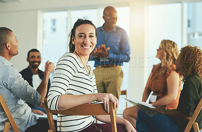 Buy stock photo Smiling business woman in a teamwork meeting feeling happy about team development success. Group of marketing workers talking about a work strategy together. Colleagues excited about a collaboration