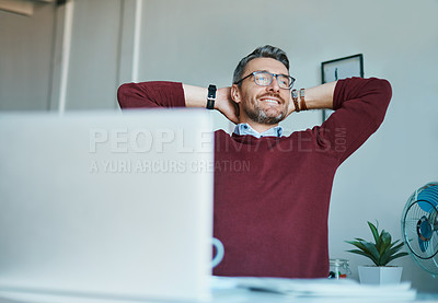 Buy stock photo Shot of a mature businessman taking a break at his office desk