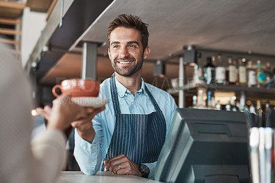 Buy stock photo Shot of a waiter serving coffee to a customer in a cafe