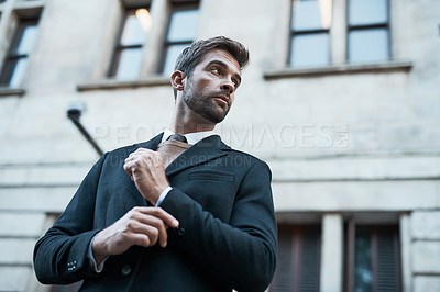 Buy stock photo Low angle shot of a handsome businessman about town