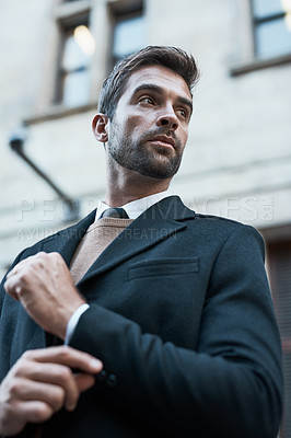 Buy stock photo Low angle shot of a handsome businessman about town