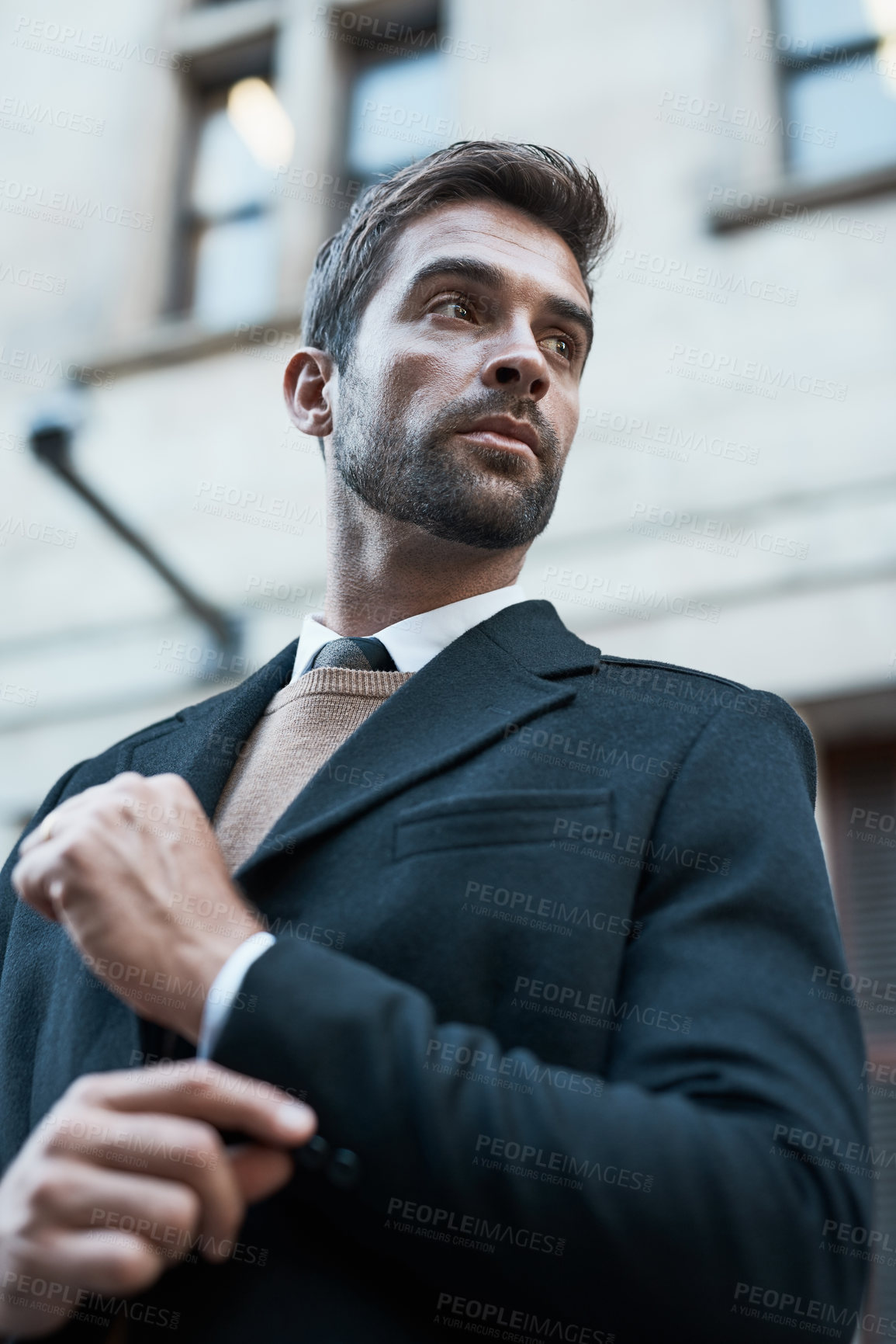 Buy stock photo Low angle shot of a handsome businessman about town