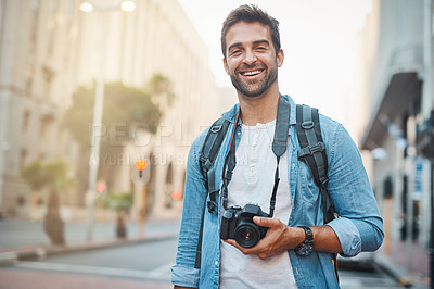 Buy stock photo Cropped shot of a young man taking photos while exploring a foreign city