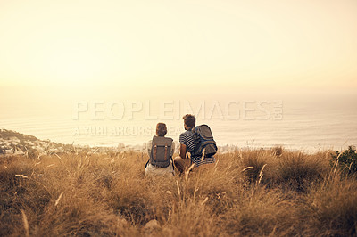 Buy stock photo Rearview shot of a couple taking a break after hiking