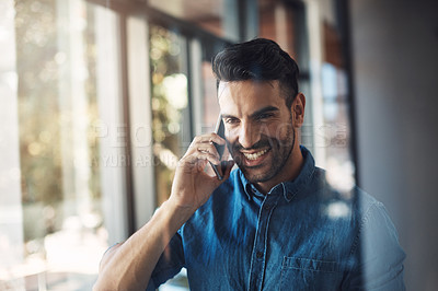 Buy stock photo Business man talking on phone while looking happy, smiling and cheerful in a modern office at work. One young male corporate professional making conversation, networking and discussing on a call