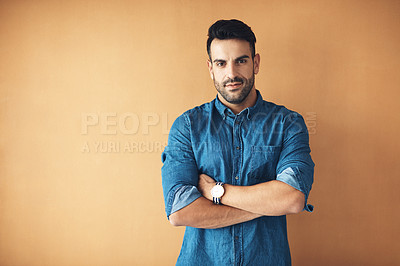 Buy stock photo Studio portrait of a handsome young man posing against a yellow background