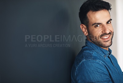 Buy stock photo Happy, confident and smiling business man or entrepreneur in an office with copy space. Ambitious and determined male employee leaning against a wall at work. Feeling positive and working for success