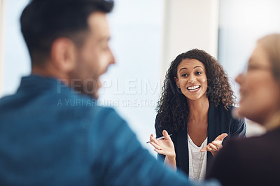 Buy stock photo Shot of a young therapist speaking to a couple during a counseling session and looking pleased