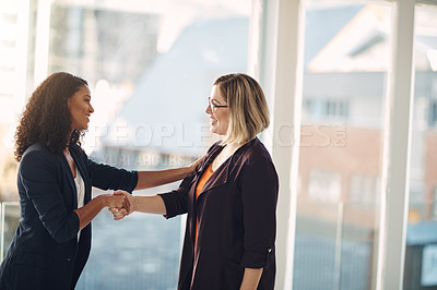 Buy stock photo Handshake, meeting and successful manager welcoming, promoting and agreeing with a talking corporate colleague. Smiling team of confident professional women collaborating and showing office teamwork