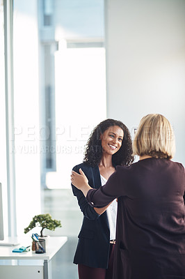 Buy stock photo Partnership, teamwork and support with a handshake between two professional business women meeting and greeting in an office. Success discussion with HR about a promotion or positive feedback