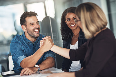 Buy stock photo Shot of a businesswoman and businessman shaking hands during a meeting in a modern office