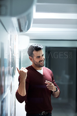 Buy stock photo Shot of a businessman presenting his ideas during a brainstorming session at work