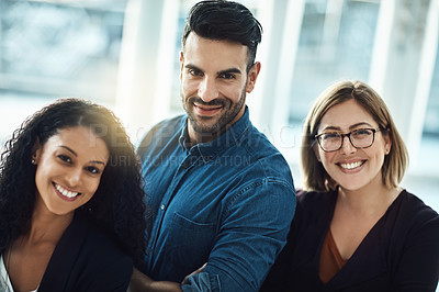 Buy stock photo Portrait of a group of happy colleagues standing together in a modern office
