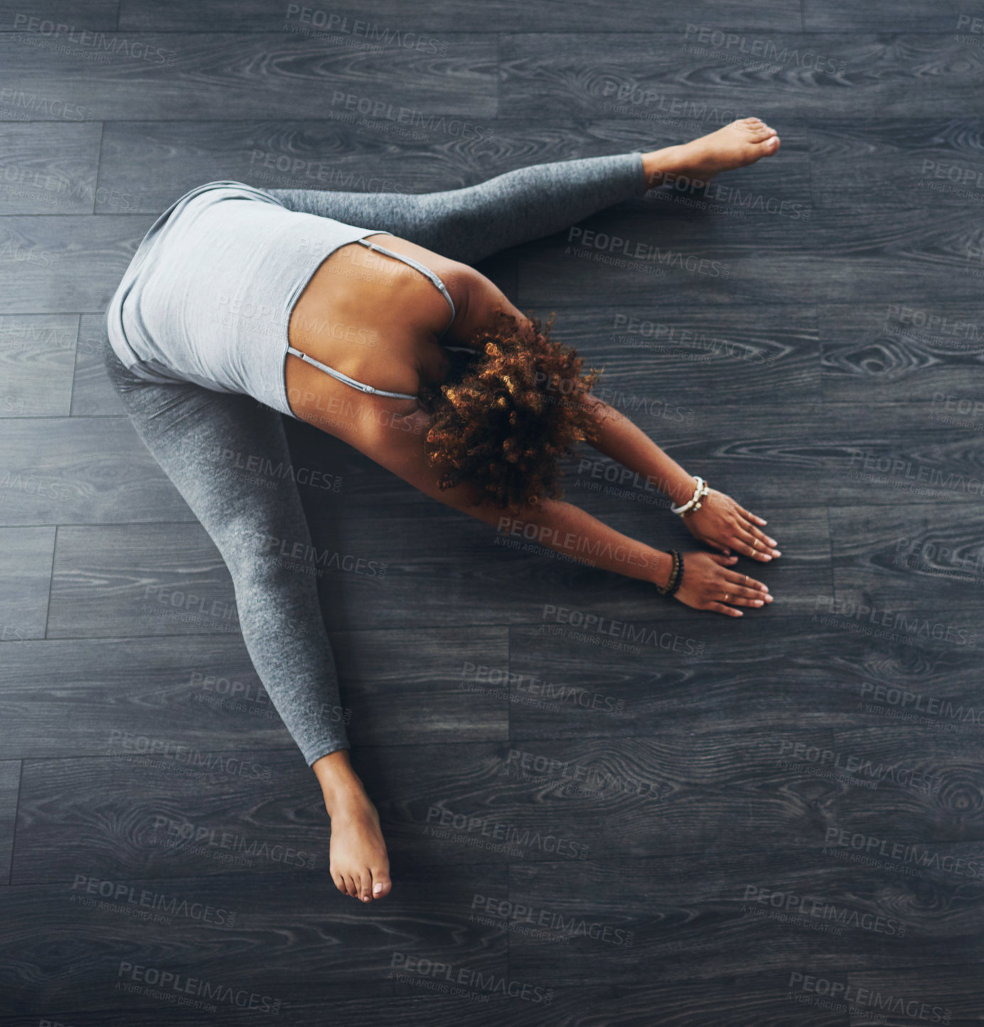 Buy stock photo High angle shot of a young woman practising yoga