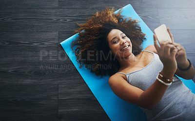 Buy stock photo High angle shot of a young woman practising yoga