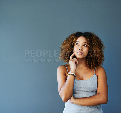 Buy stock photo Studio shot of an attractive young woman against a grey background