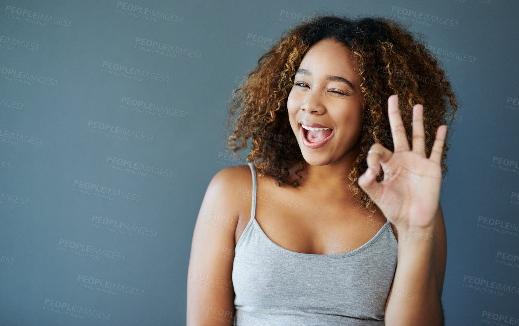 Buy stock photo Girl, happy and ok sign with studio portrait, emoji and decision with agreement by background. Woman, person and model with pride with icon, symbol and mockup space for choice with wink in Costa Rica